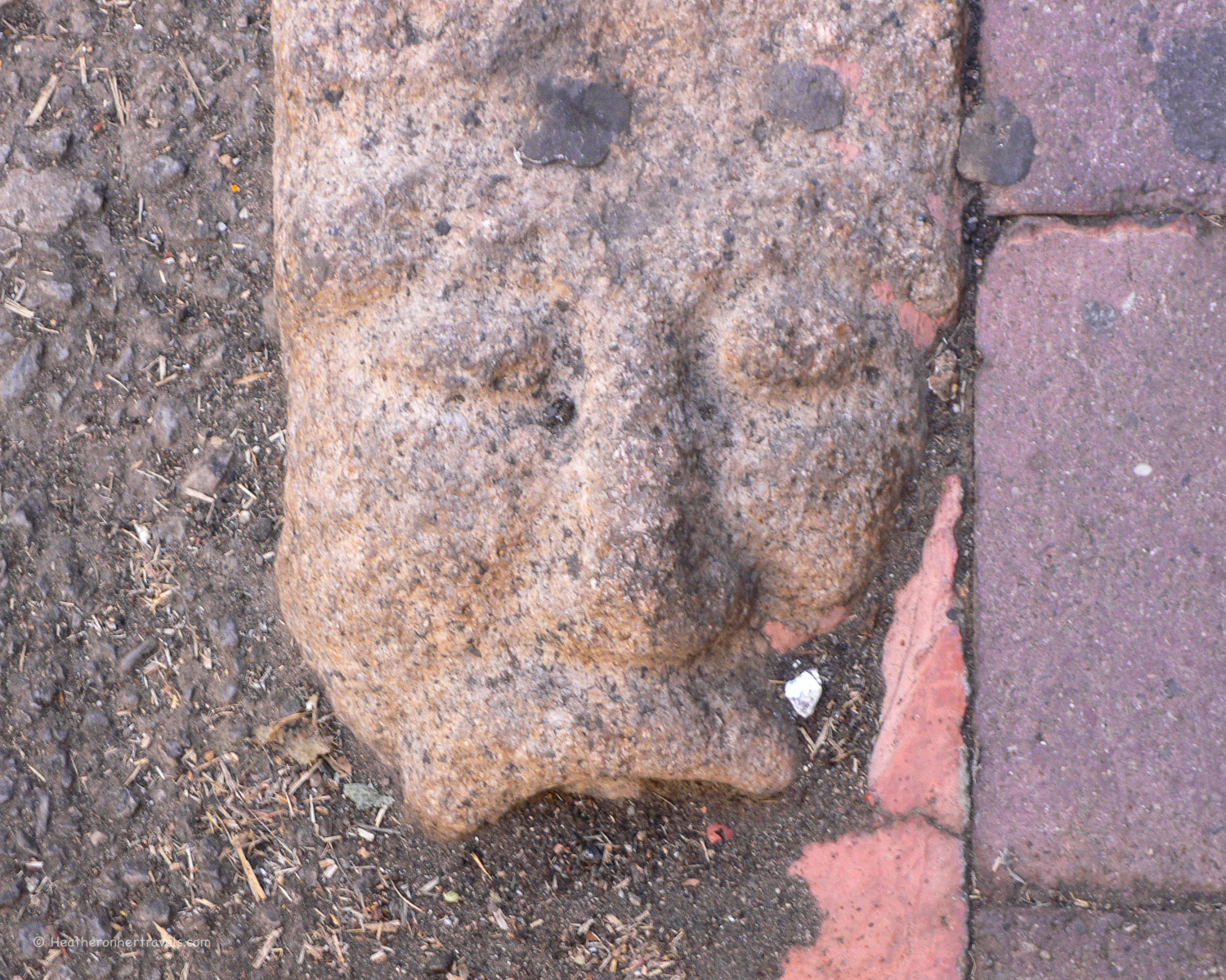 Carved faces kerb stones in Nuoro, Sardinia