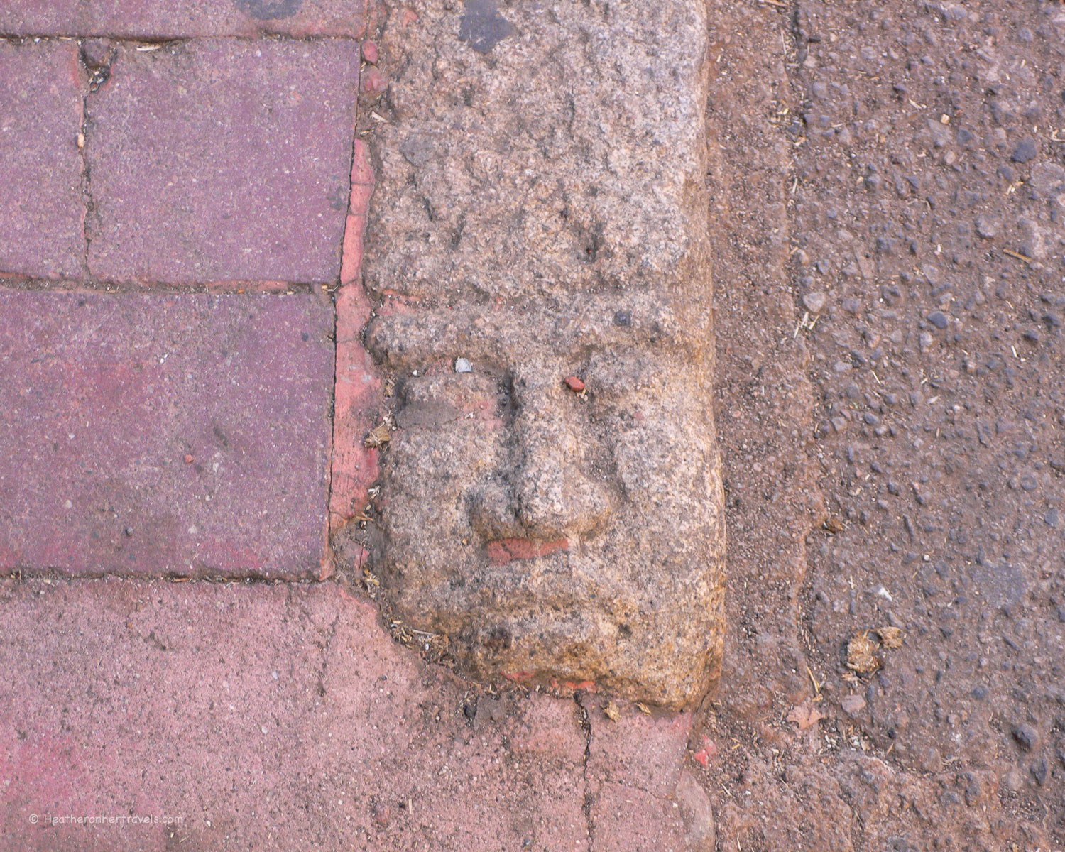Faces carved in the kerb stones in Nuoro,Sardinia