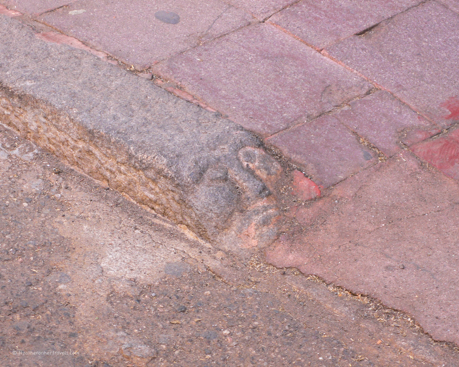 Faces carved in the kerb stones in Nuoro,Sardinia