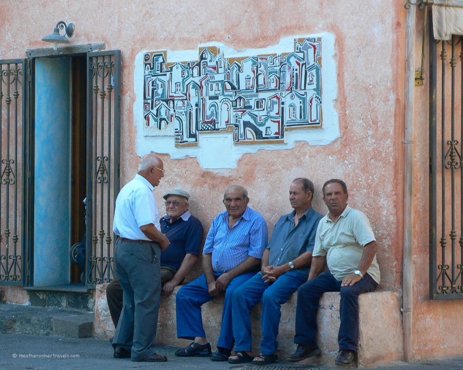 Old men chat in the square in Sardinia