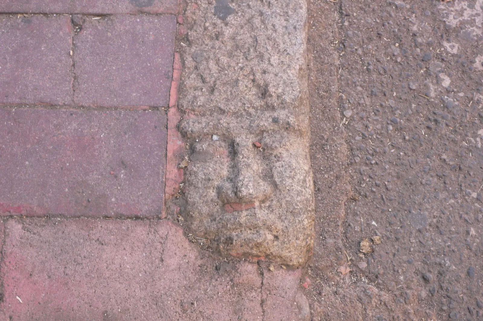 Carved faces kerb stones in Nuoro, Sardinia