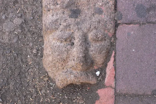 Carved faces kerb stones in Nuoro, Sardinia
